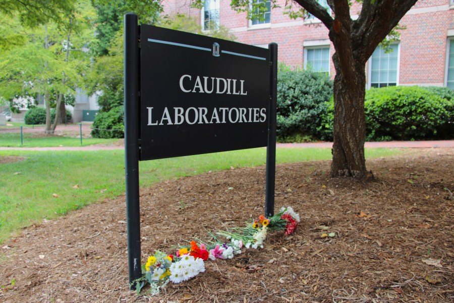 Flowers are seen piled up in front of Caudill Laboratories, Tuesday, Aug. 29, 2023, on the UNC-Chapel Hill campus, where a graduate student fatally shot his faculty advisor this week in Chapel Hill, N.C. (AP Photo/Hannah Schoenbaum)