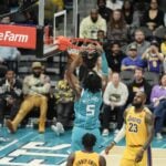 Jan 27, 2025; Charlotte, North Carolina, USA; Charlotte Hornets center Mark Williams (5) dunks the ball against Los Angeles Lakers forward LeBron James (23) during the second half at the Spectrum Center. Mandatory Credit: Jim Dedmon-Imagn Images